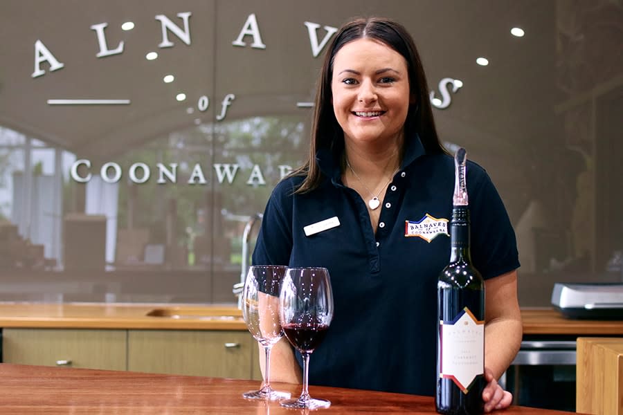 Laura woman smiling with wine and tasting glasses