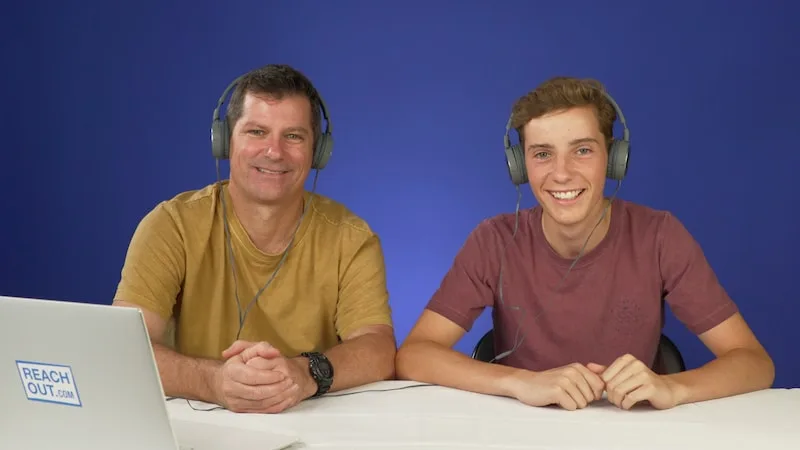 shane and his son josh sitting down infront of a laptop