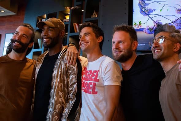 queer eye fab five group of give men standing together smiling