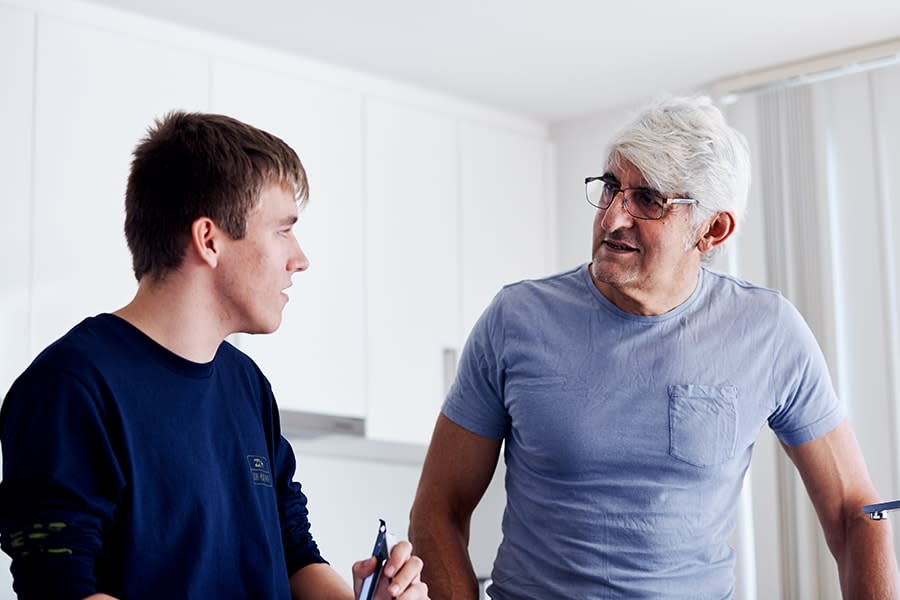 father and son talking in the kitchen