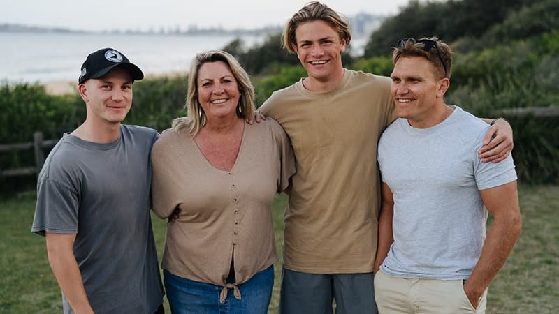 mother son and two friends smiling with arms around each other