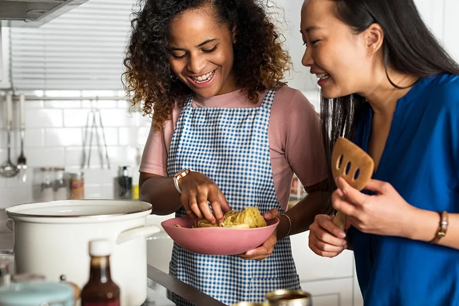 two girls in kitchen cooking