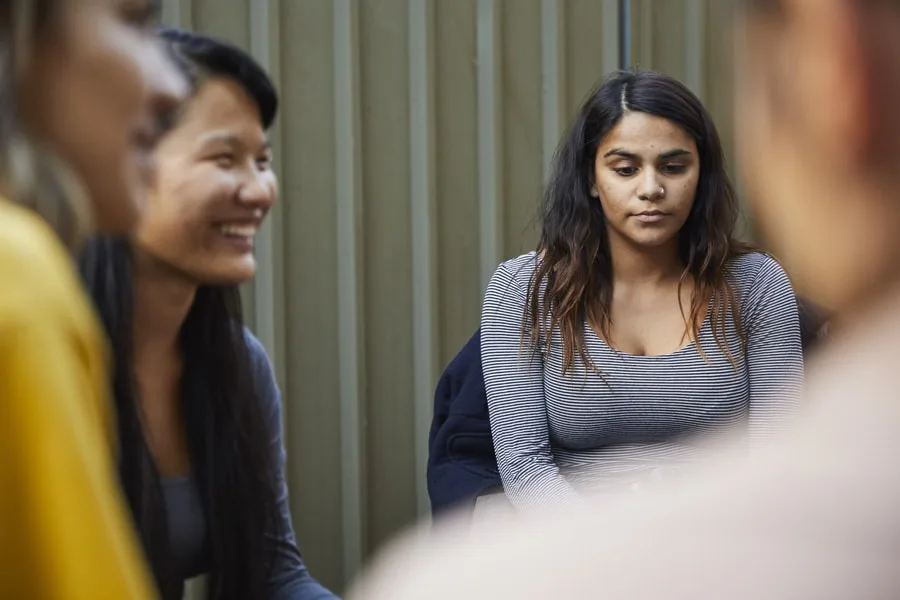 Girl looking upset in a group of people