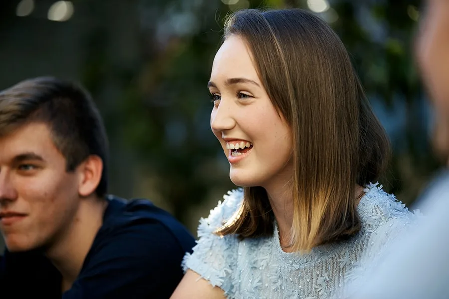 girl sitting with friends laughing