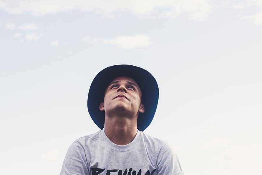 Boy wearing hat looking at sky