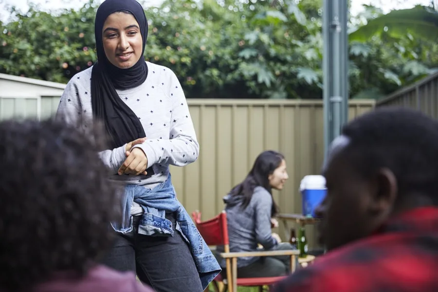 girl standing talking to friends