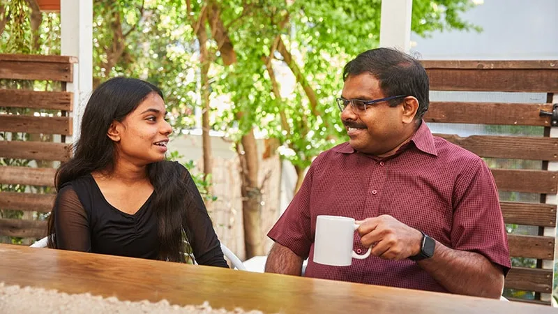 father and daughter smiling and talking