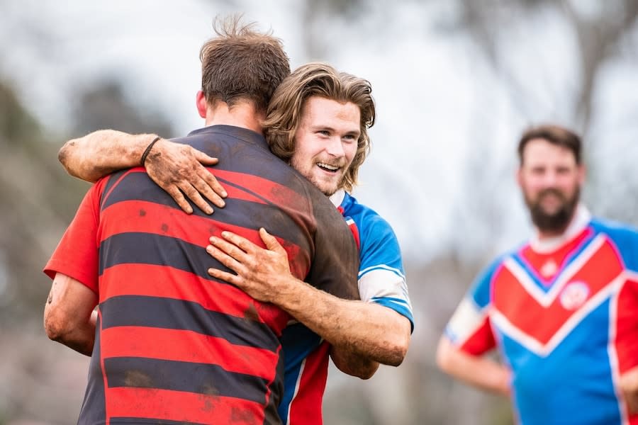 two mates on different rugby teams hugging it out