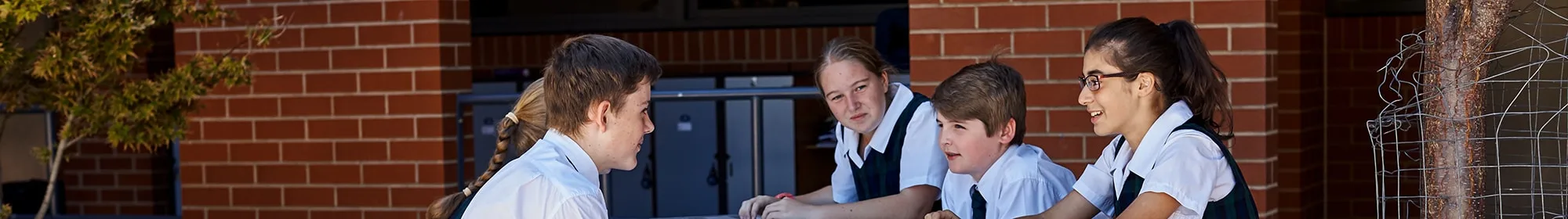 friendships banner friends in school uniform sitting at lunch table