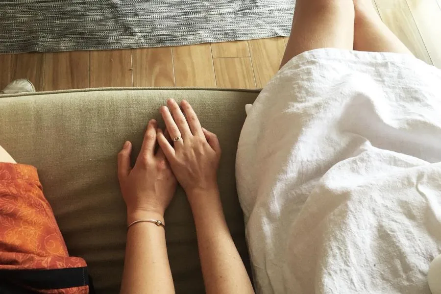 Aerial close up of 2 girls holding hands