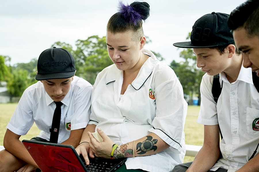 students using laptop outside