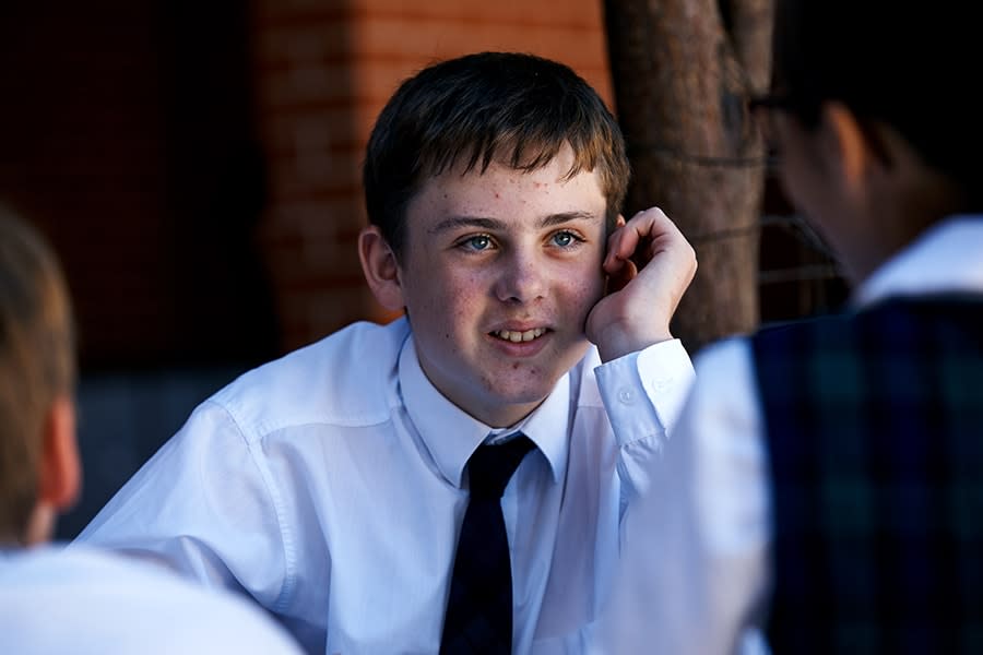 schoolboy looking at friends