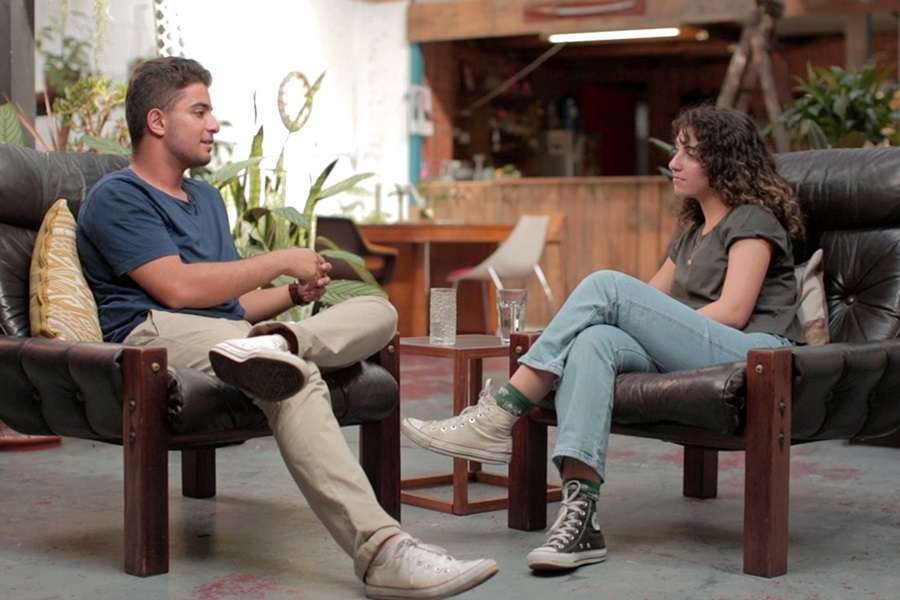 Boy and girl sitting in chairs and talking