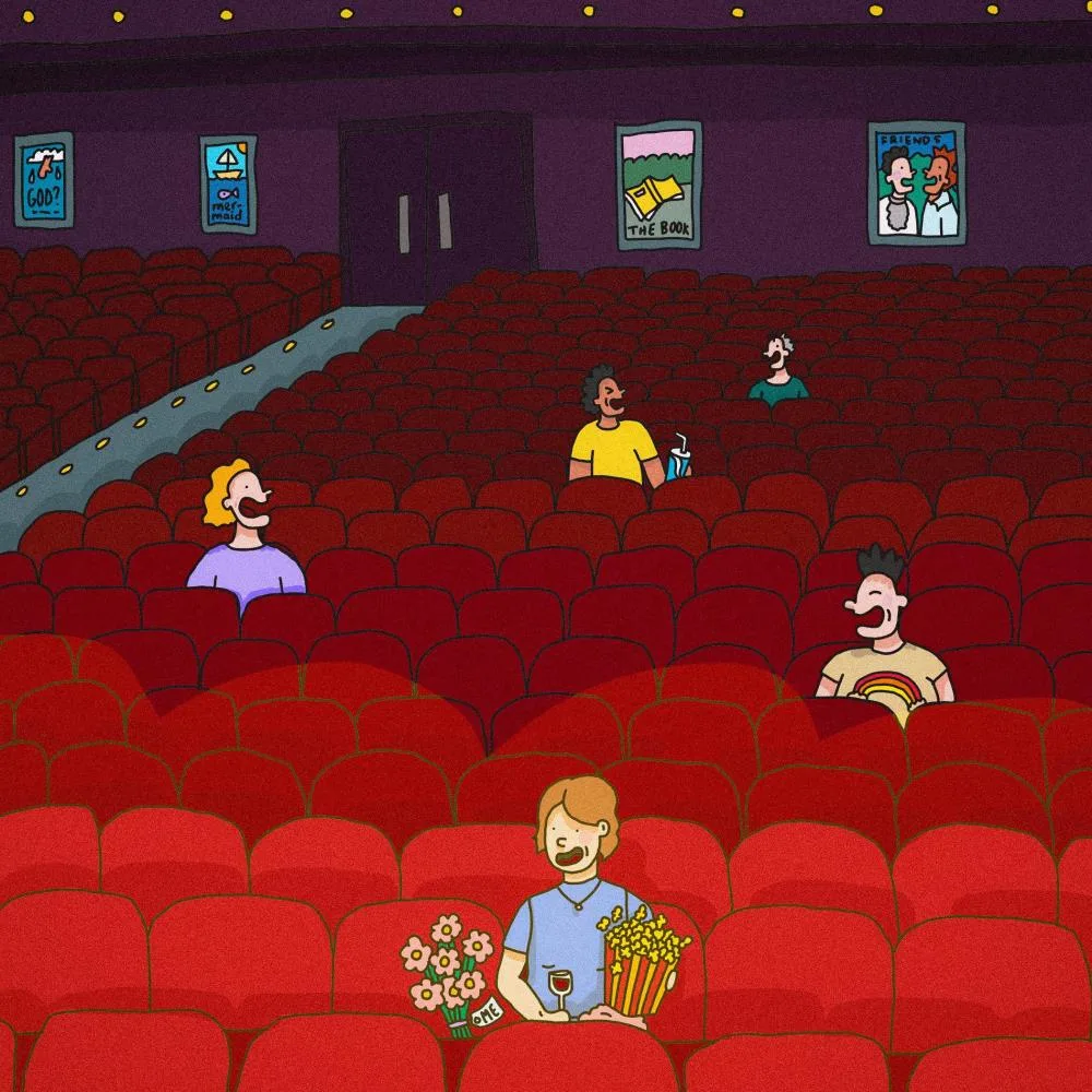 Person sitting alone in movie theatre