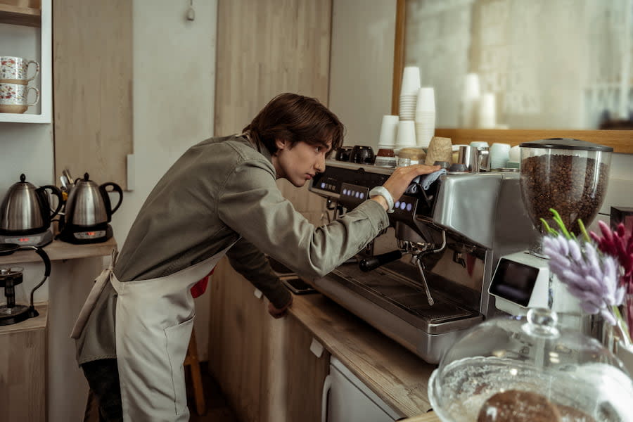 Image of a teenage boy working as a barista.