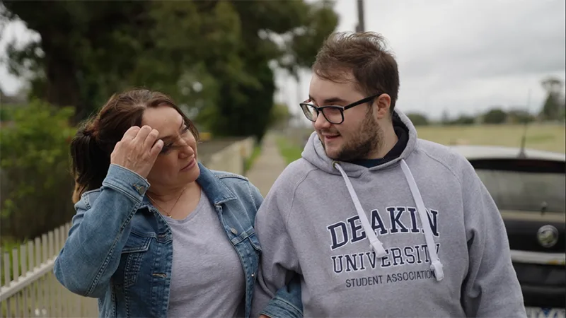 chase young man and his mum walking side by side