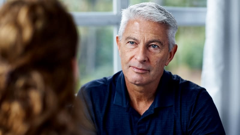 father having conversation with daughter at home