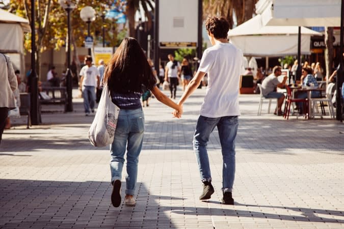 Couple holding hands in mall