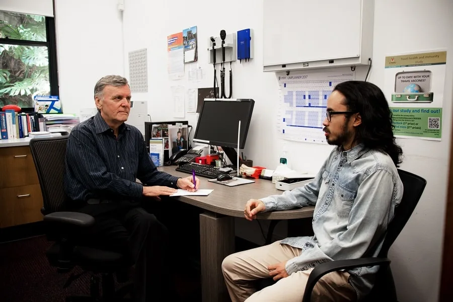 Boy in denim shirt talking to a gp