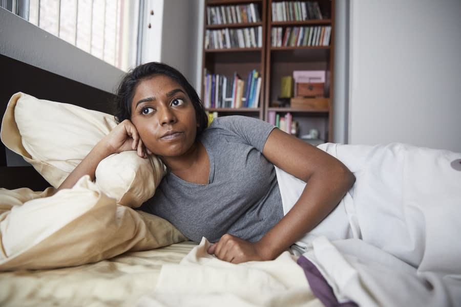 girl in bed looking bored