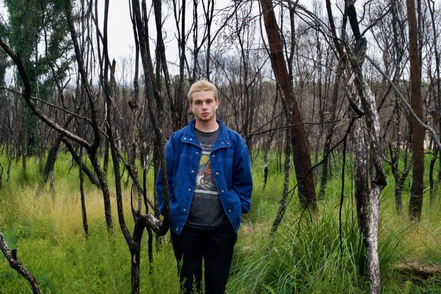 young man standing in the bush