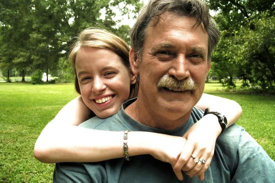 Father and daughter smiling