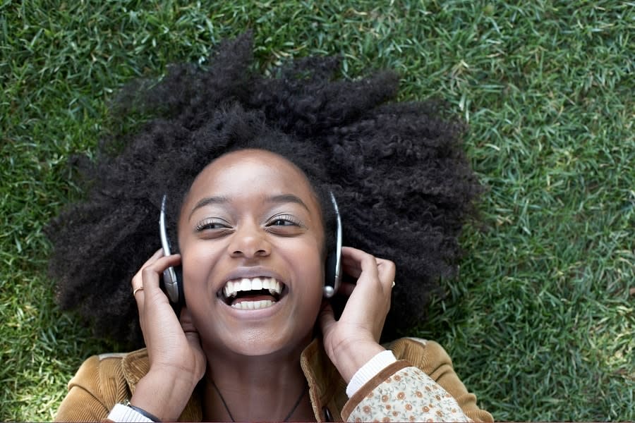 girl listening to music on grass