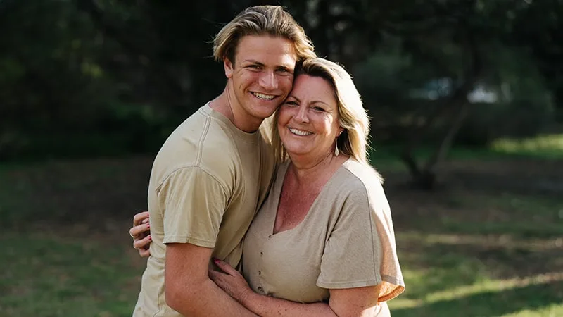 mother and son hugging in park