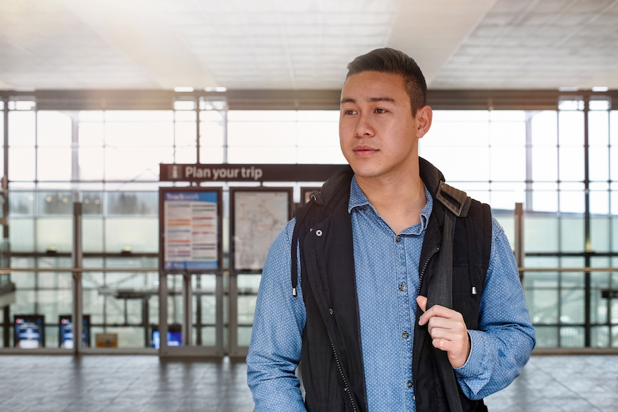 Young man at airport staring to his right