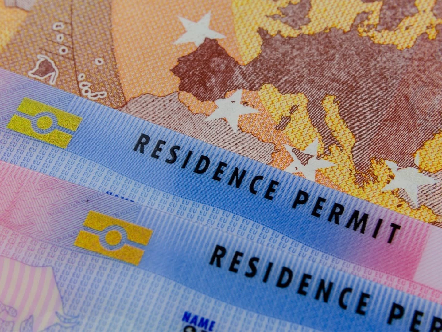 residence permit card on a euro bill