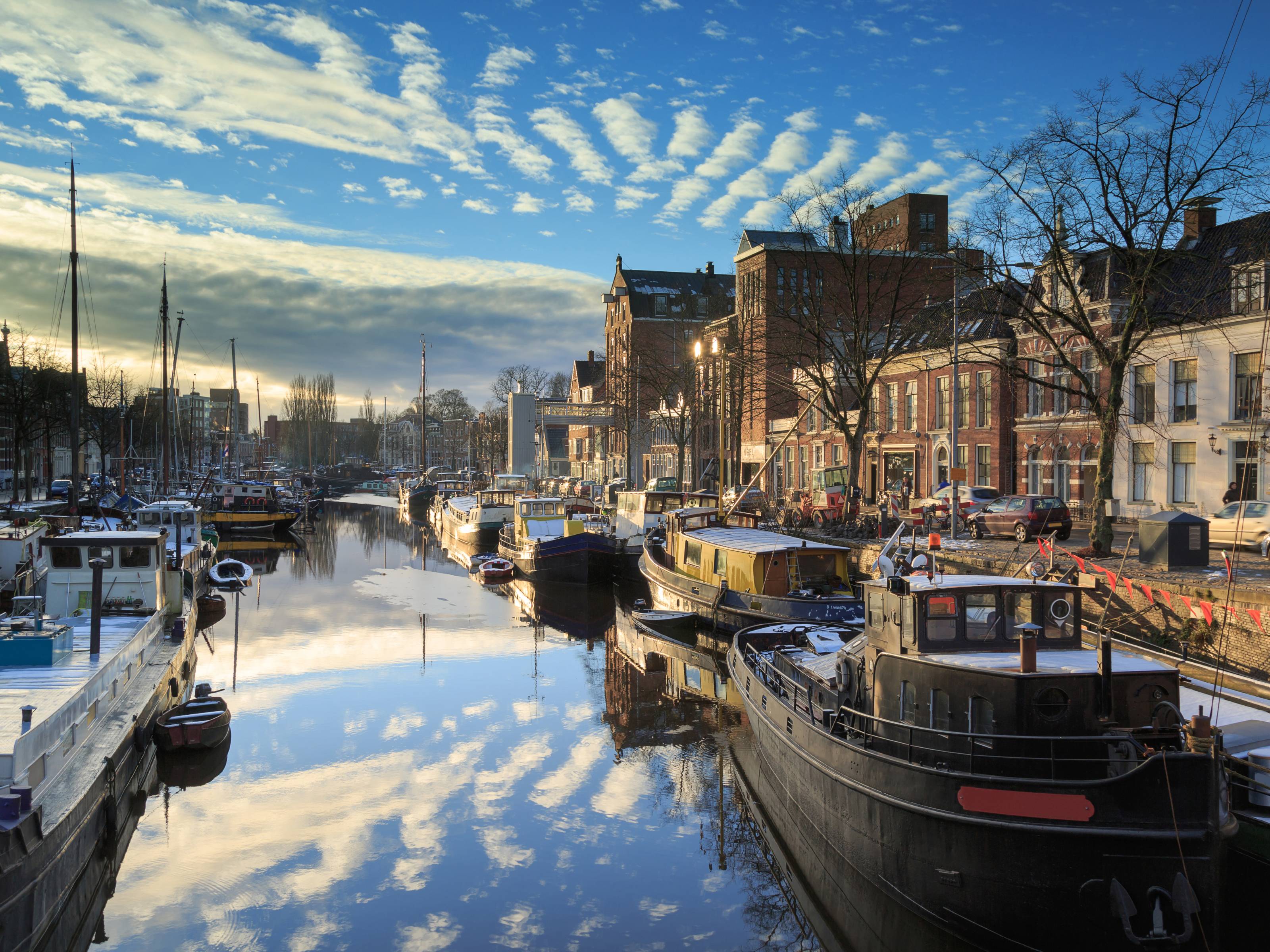 View of one of Groningen's canals with boats and trees