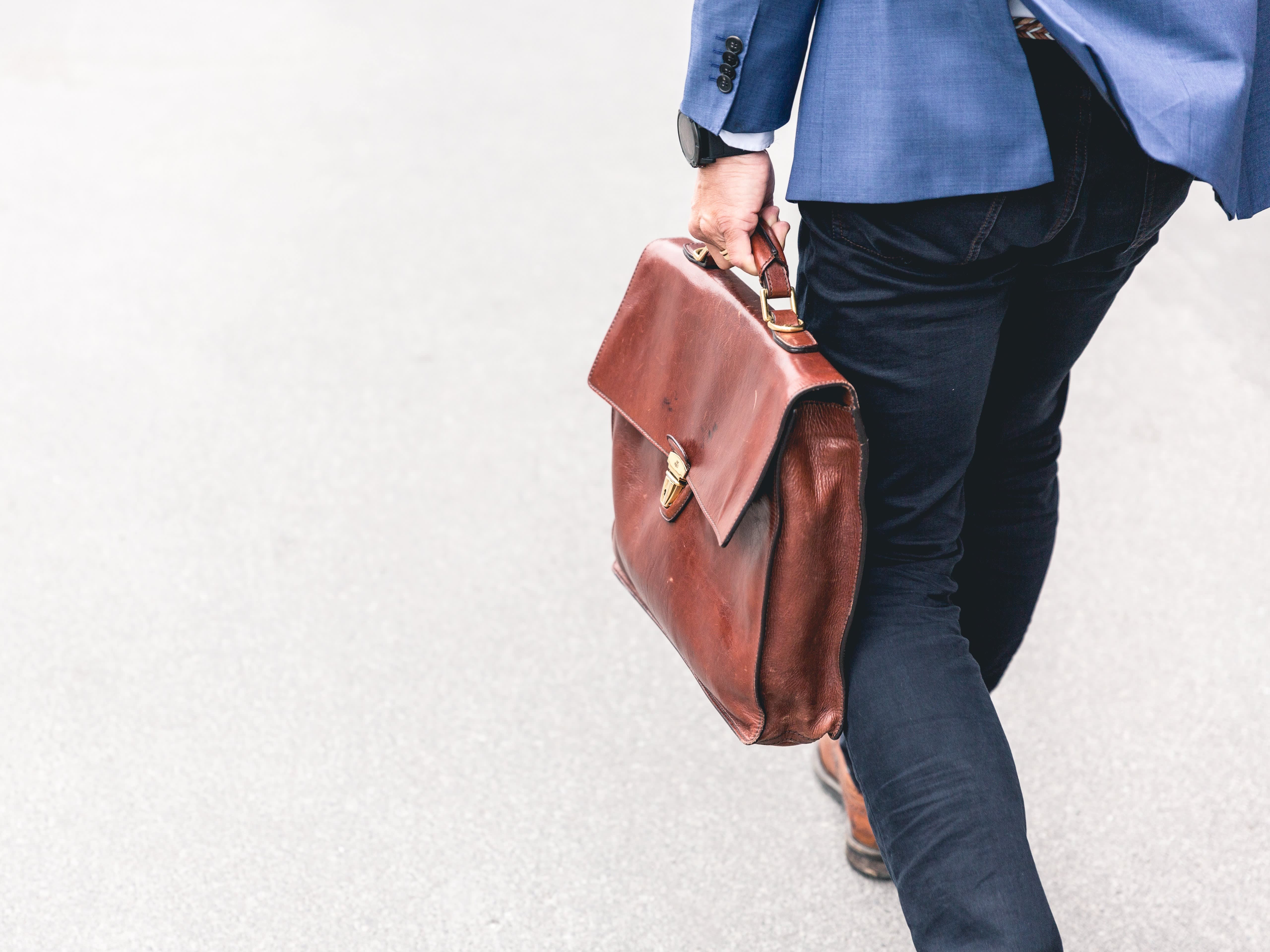 man in a suit with a leather briefcase