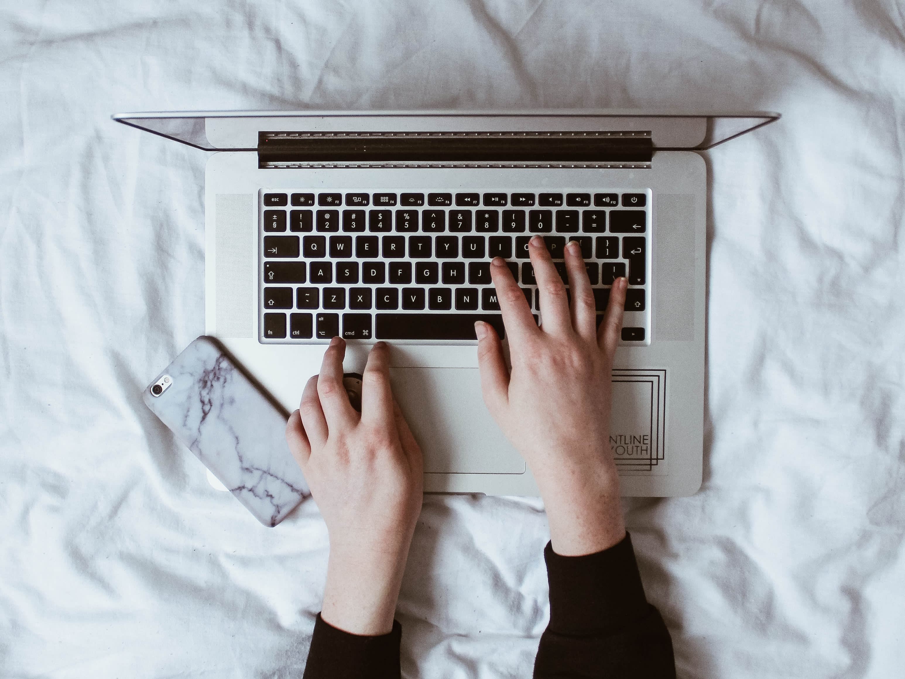 A female using a laptop to research the conditions for a Spanish residence visa