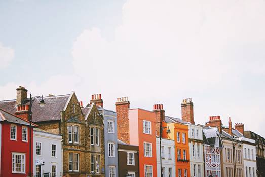 Higher view of colorful building next to each other, with a white  bright and cloudy sky