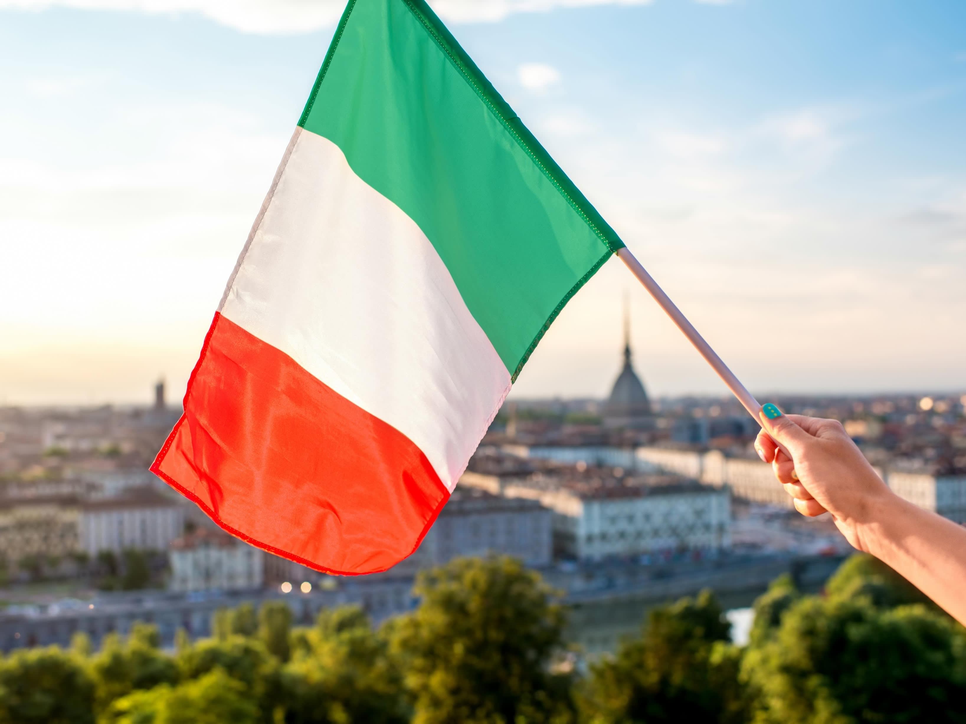 Italian flag on the backdrop of Turin's skyline