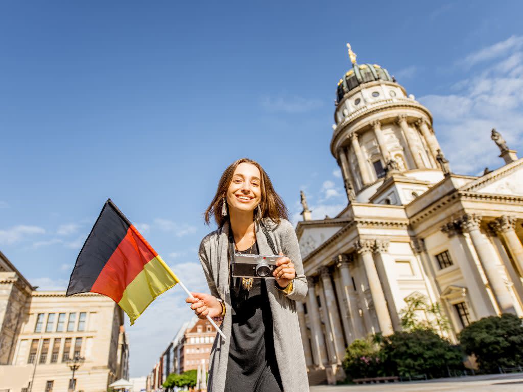 Girl smiling, holding a German flag