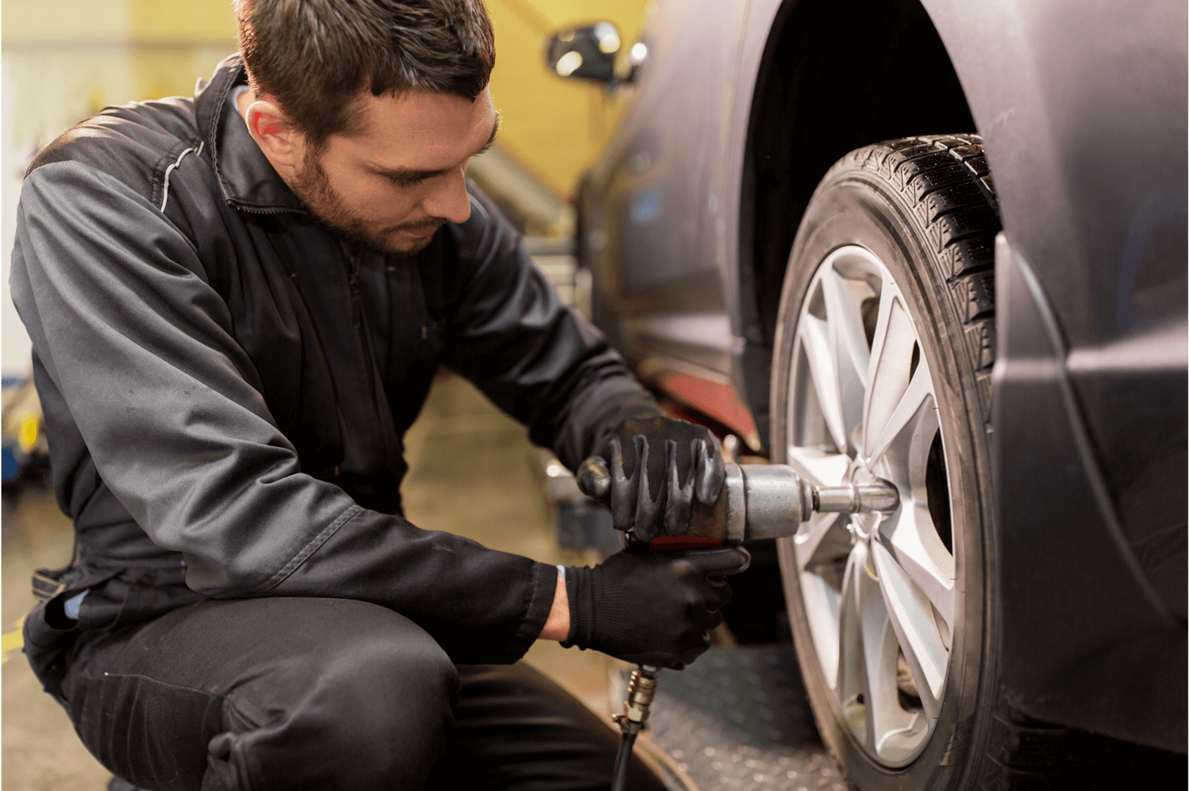 Autoserve man servicing EV
