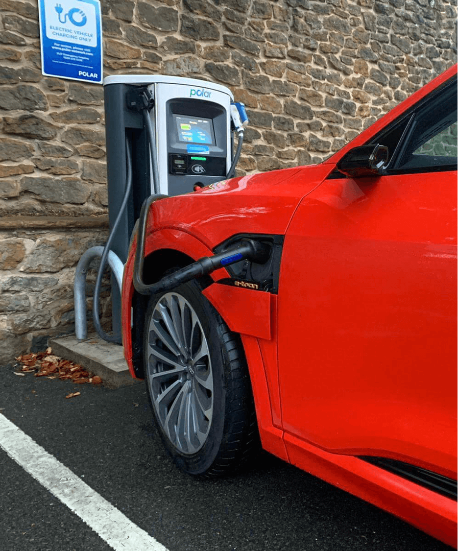 Red car charging on polar