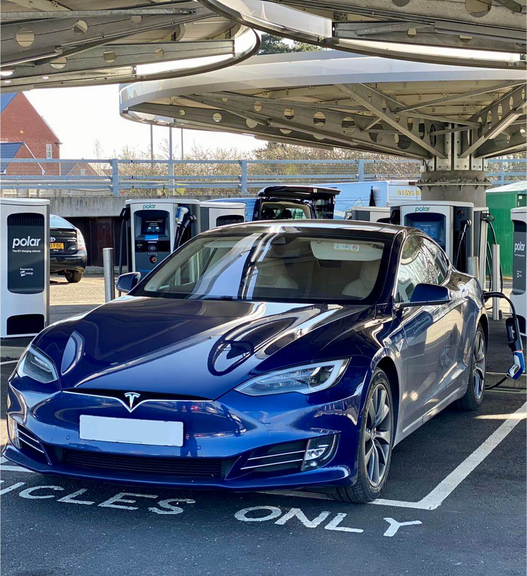 Blue Tesla charging at Polar
