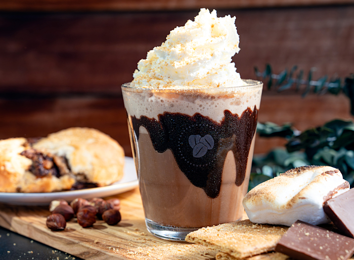 Image of a iced Campfire Frappe with Chocolate, Cookies and Marshmallows around it