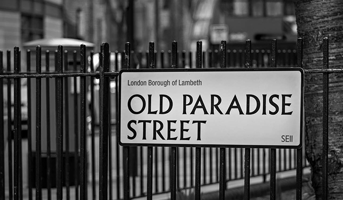 Black and White photo of a London Street sign for  Old Paradise Street, in SE11 London.  One of the original Costa Coffee Roastery Locations.