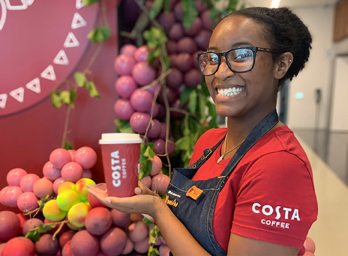 Costa employee holds To Go cup in hand 