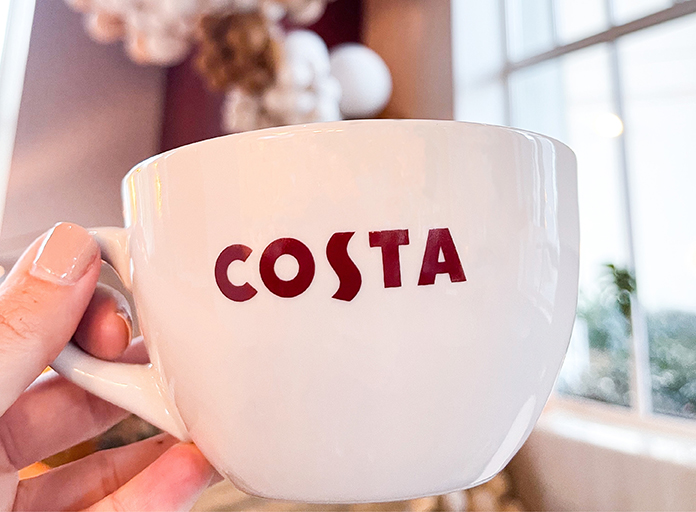 Costa Cup holding by a hand