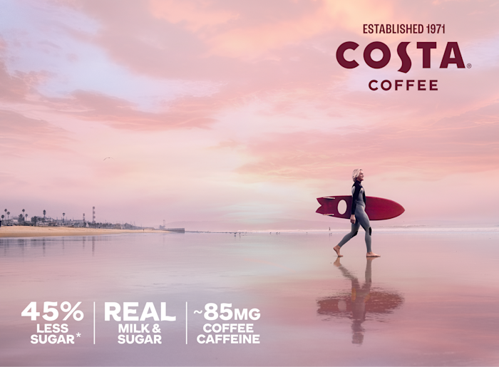 Picture of a surfer holding a surfboard on a beach at dawn. The copy states that there is 45% less sugar, plus real milk and sugar and 85 mg coffee caffeine per can. *Than the leading RTD coffee beverage SIGNATURE: 13g sugar 11oz. Leading unflavored: ~26g sugar per 11oz. Caramel: 13g sugar 11oz. Leading caramel: ~37g sugar per 11oz. Mocha: 13g sugar 11oz. Leading mocha: ~37g sugar per 11oz.
