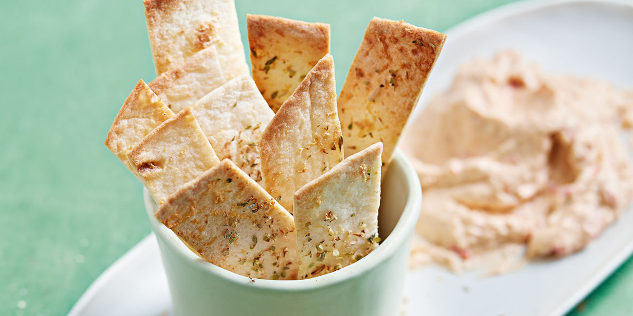Tortilla chips with red pepper houmous