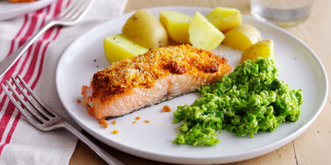 Salmon with pesto topping and herby mushed peas