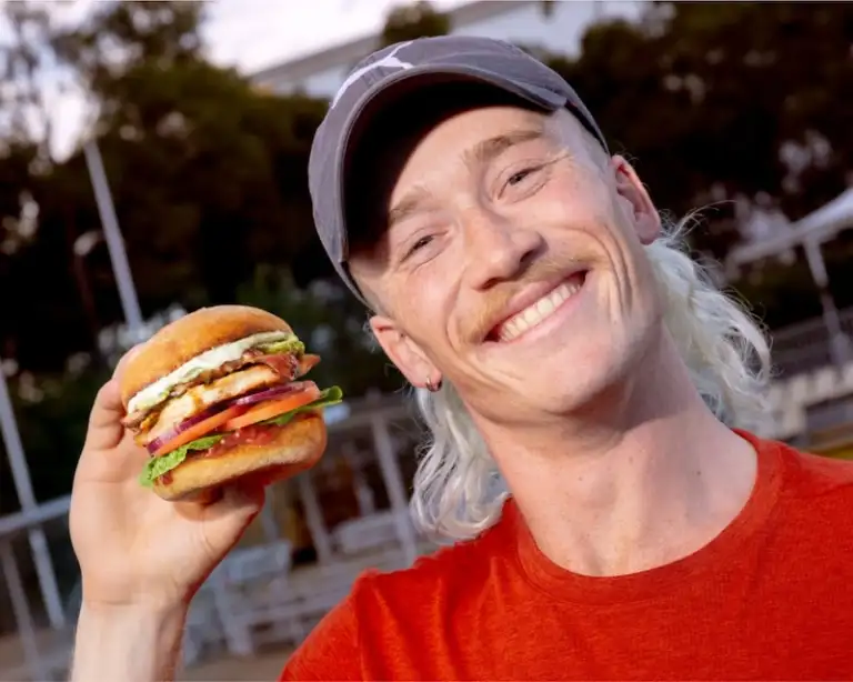 Nedd Brockman holding a Simon Says burger