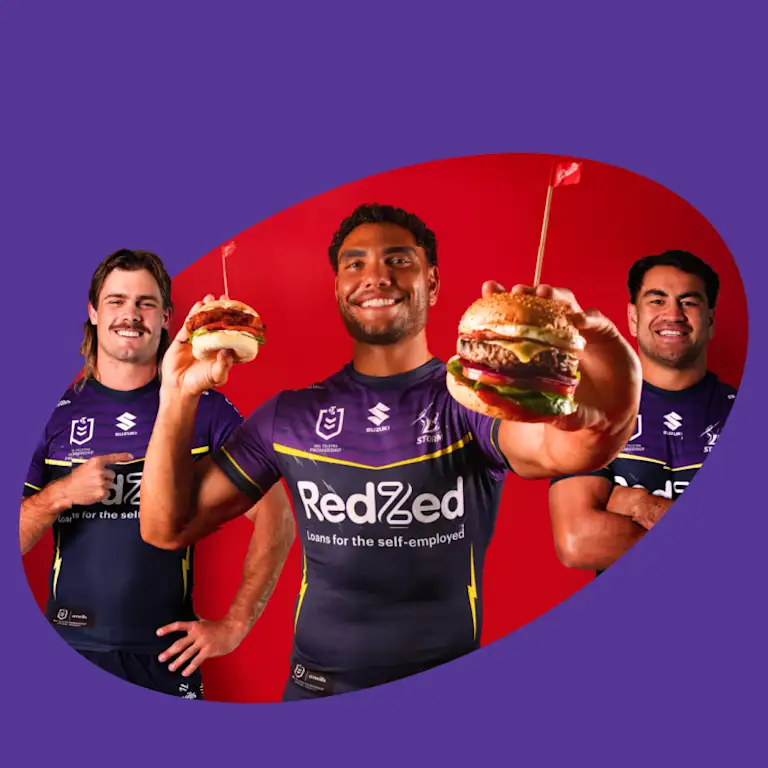 Storm player holding two Grill'd burgers 