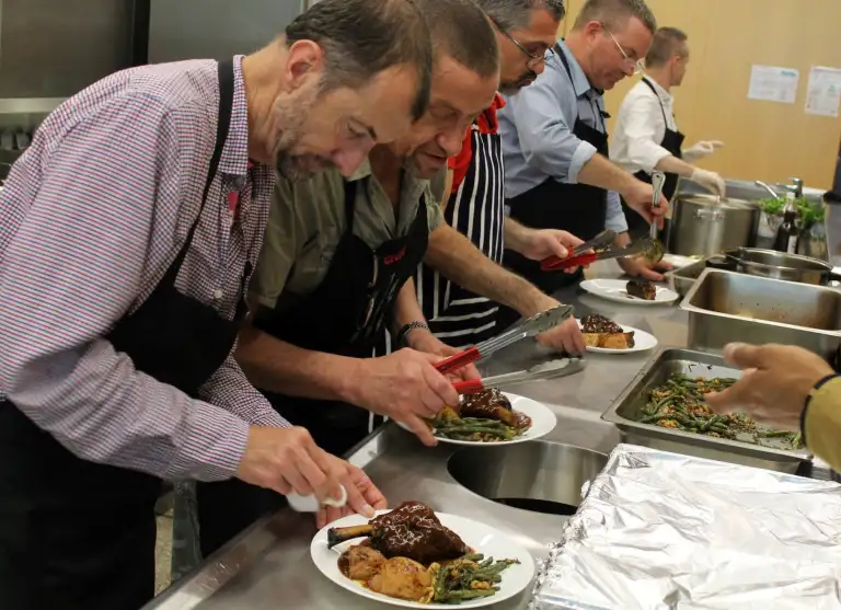Members of Bobby Goldsmith Foundation plating meals