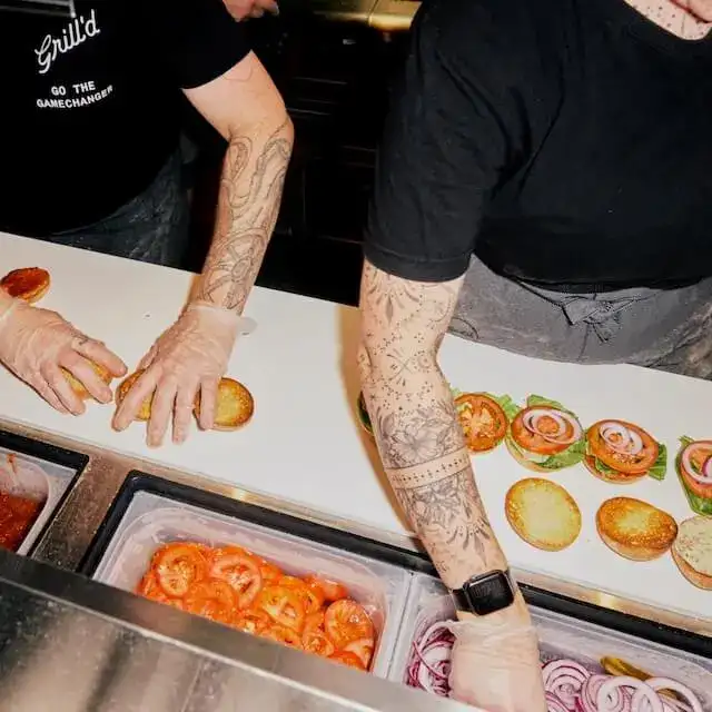 Grill'd team members preparing burgers